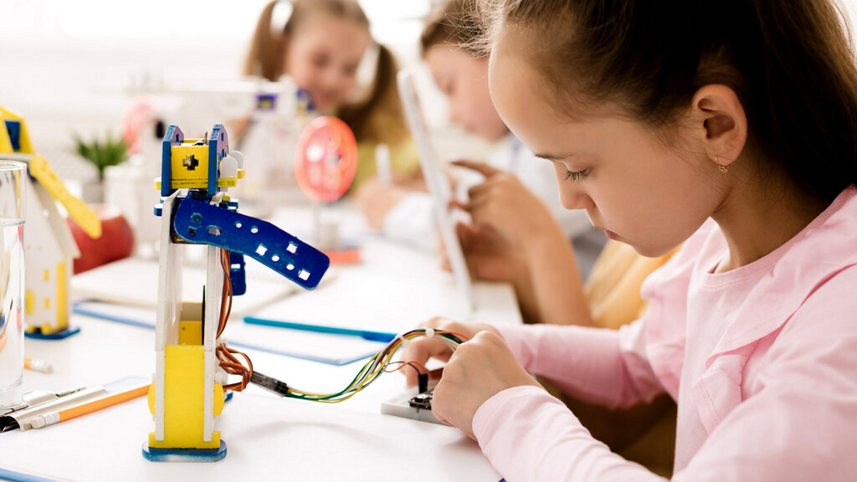 A young girl engaging in STEM learning through robotics.
